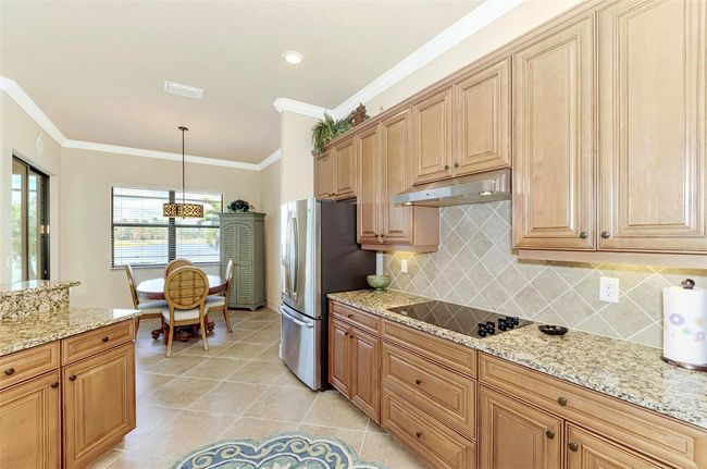 Honey-Glazed Maple Cabinetry, Stainless and Granite Counters | Image 27