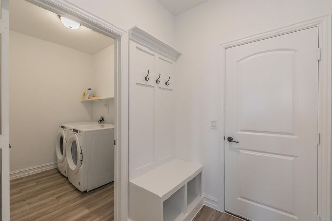 Mudroom featuring washer and dryer and dark wood-type flooring | Image 20