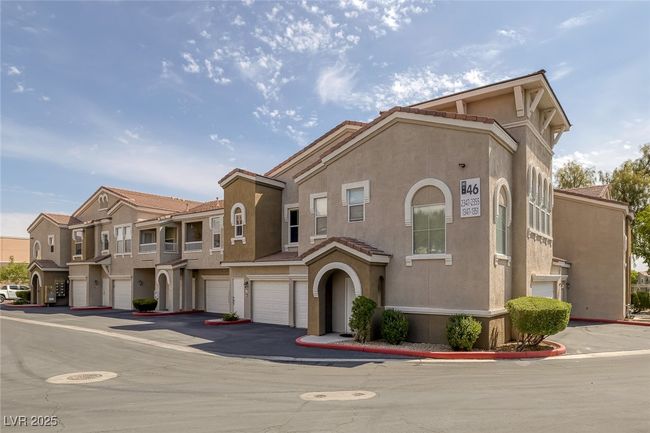 View of front of home featuring stucco siding, a tile roof, an attached garage, driveway, and a residential view | Image 30