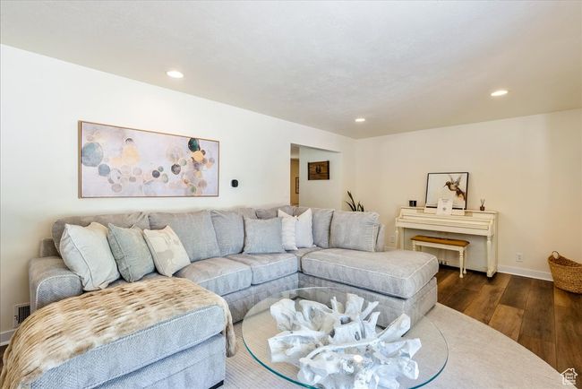 Living room with dark wood-style flooring and recessed lighting | Image 15
