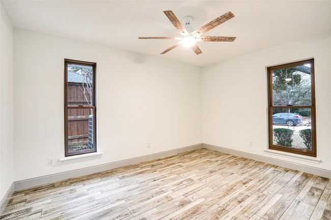 Spare room with light wood-style floors, ceiling fan, and baseboards | Image 16