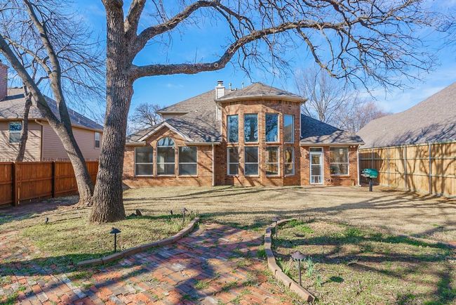 Back of house with a chimney, brick siding, a lawn, and a fenced backyard | Image 26