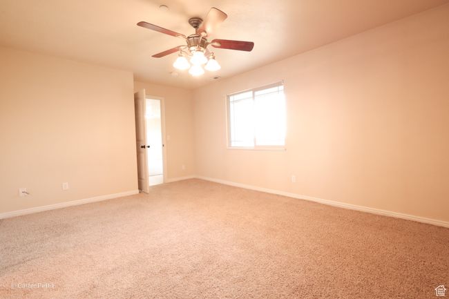 Spare room with light carpet and a ceiling fan | Image 15