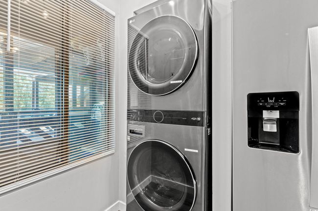 Laundry room featuring stacked washing machine and dryer | Image 5