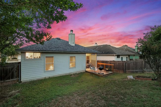Relax on the covered back patio or deck offering the perfect spot to watch the sunset in your private, fenced in yard. | Image 36