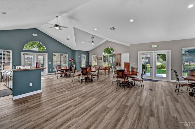Dining area featuring ceiling fan, light wood finished floors, recessed lighting, french doors, and high vaulted ceiling | Image 25