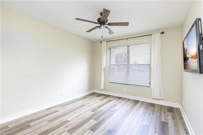 Unfurnished room with baseboards, light wood finished floors, and ceiling fan | Image 12