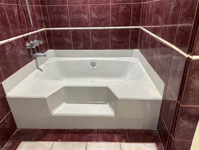Bathroom featuring a washtub and tile patterned floors | Image 4