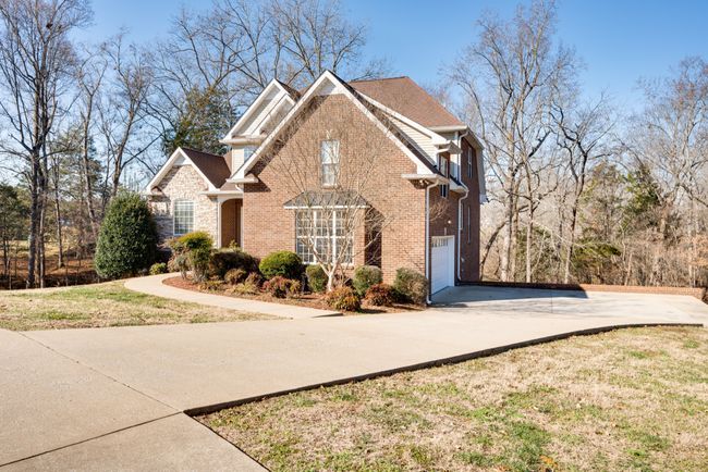 Paved, level driveway yields extra parking with a 2 car garage. | Image 4