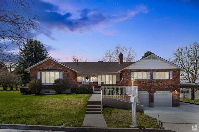 Ranch-style house with brick siding, a yard, a garage, and concrete driveway | Image 47