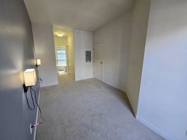 Unfurnished room featuring electric panel, light colored carpet, and baseboards | Image 12