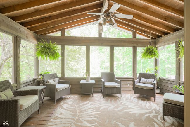 sunroom / solarium with a ceiling fan and vaulted ceiling | Image 24