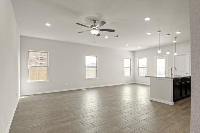 Unfurnished living room with ceiling fan, recessed lighting, and light wood finished floors | Image 7
