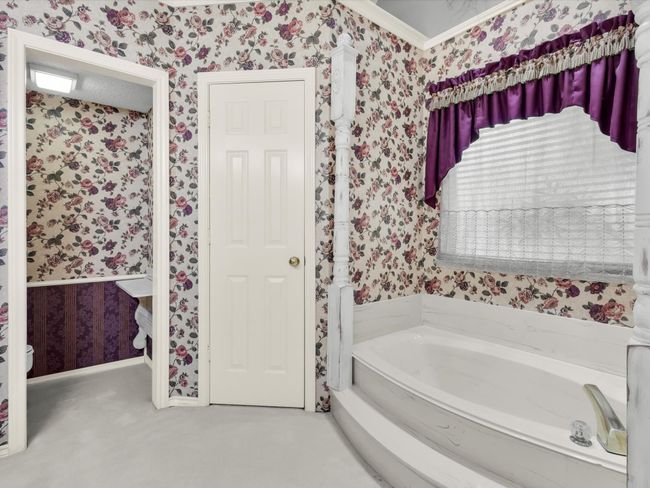 Primary bath has two large walk-in closets and separate toilet area. | Image 29