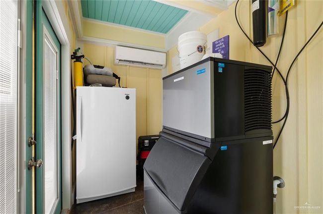Utility room featuring an AC wall unit | Image 14