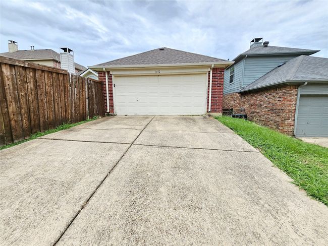 View of side of home with brick siding and a garage | Image 32