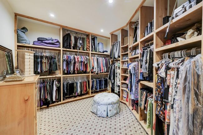 One of two oversized closets with built in clothing racks and drawers. | Image 25