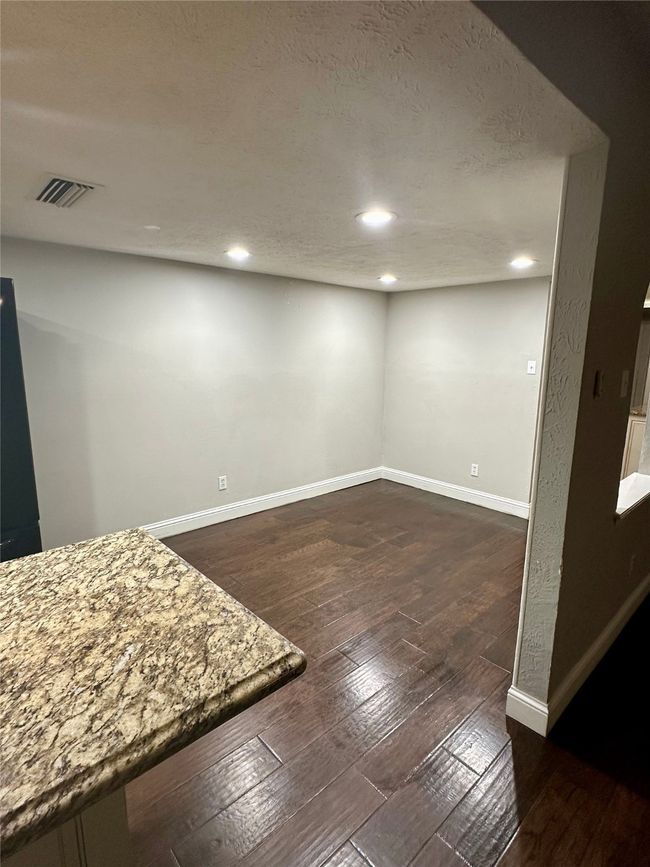 Breakfast area featuring a textured ceiling, dark wood finished floors, and recessed lighting | Image 11