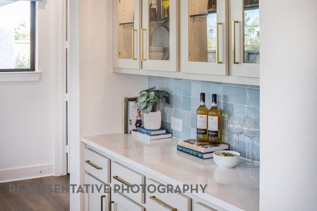Bar area with backsplash and dark wood-type flooring | Image 6
