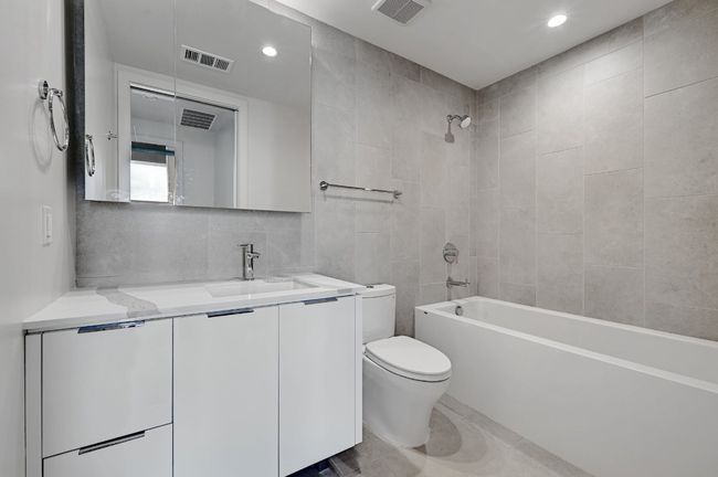 Full bathroom featuring shower / bath combination, visible vents, and toilet | Image 13