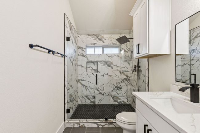 Bathroom with a marble finish shower and vanity | Image 18