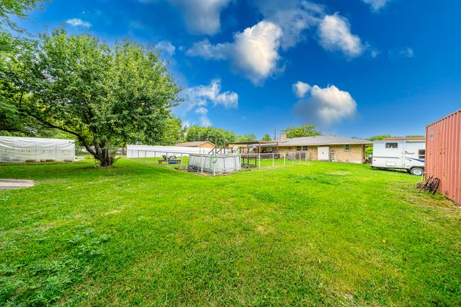View of yard featuring a greenhouse and an outdoor structure | Image 6