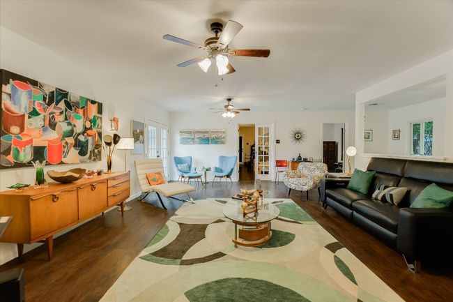 Living room with french doors, wood finished floors, and ceiling fan | Image 4
