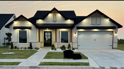 Craftsman-style home featuring a garage and a yard | Image 1