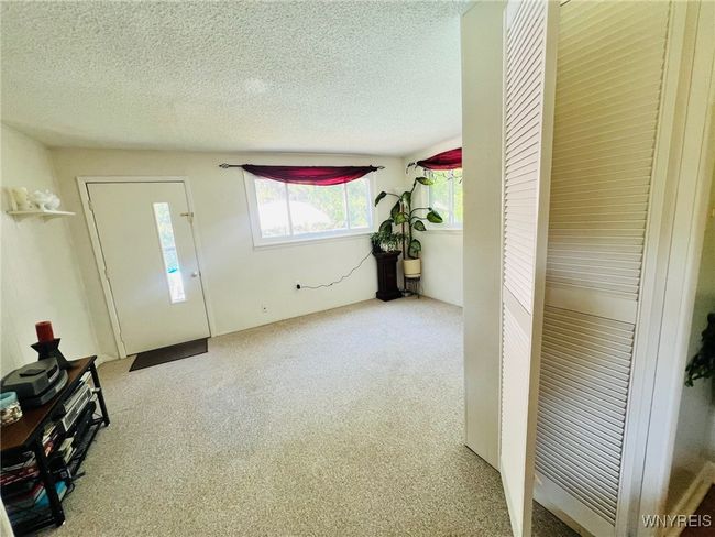 family room/entertaining is off dining room with bifold doors and door to patio! | Image 17