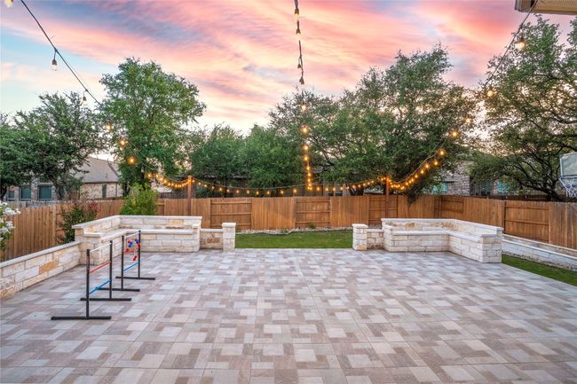 Fenced backyard with a patio | Image 35