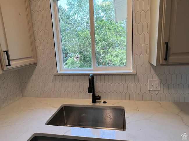 Kitchen view of backsplash and light stone countertops | Image 5