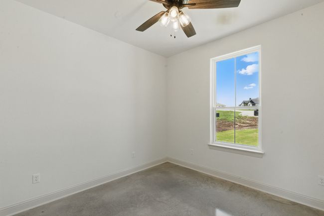 Empty room with baseboards, concrete flooring, and a ceiling fan | Image 19