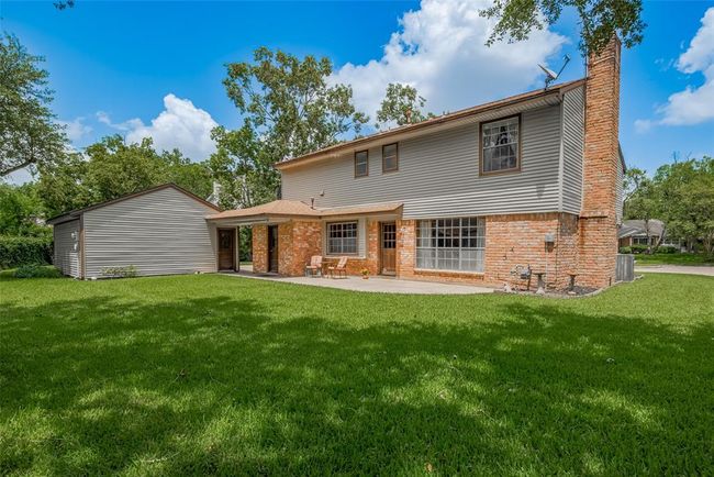 Expansive backyard with lush green lawn, perfect for relaxation and outdoor gatherings. | Image 35