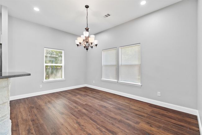 Unfurnished living room with an inviting chandelier | Image 6