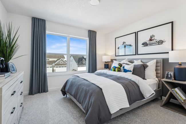 Photo is of the actual model. One of three generously sized upper level secondary bedrooms with spacious closets. | Image 24
