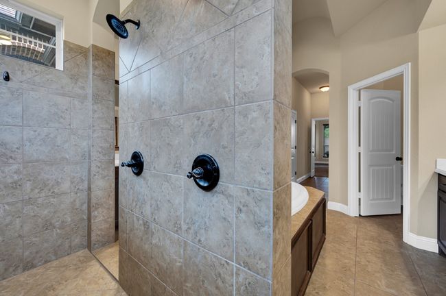Full bath with walk in shower, vanity, tile patterned floors, and a bathtub | Image 20