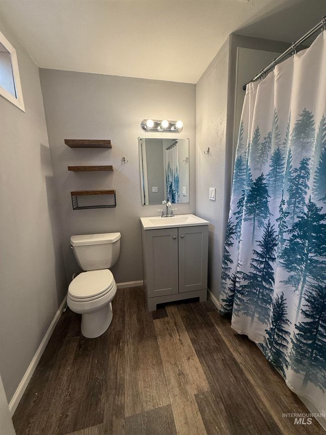 Bathroom featuring wood finished floors, vanity, and a shower with curtain | Image 30
