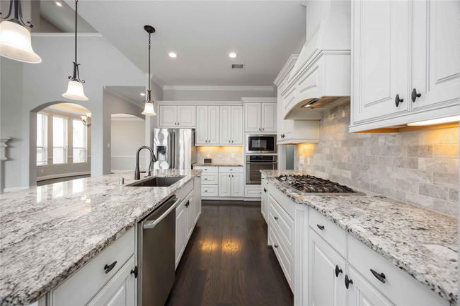 Stunning kitchen designed for gourmet cooking, featuring elegant light-toned countertops, a thoughtfully arranged interior layout, and warm ambient lighting that creates an inviting atmosphere. | Image 17