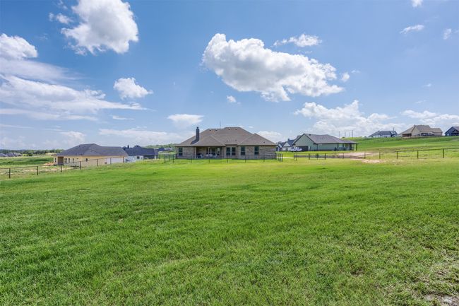 Another view of the double fenced area. A smaller area closer to the home is fenced along with the perimeter of the property. This is an enormous upgrade for this property making it truly move-in ready. | Image 28