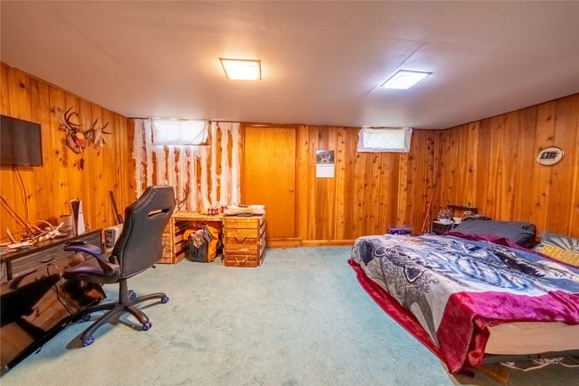 Carpeted bedroom with wooden walls | Image 39