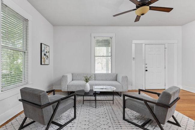 Living room featuring light wood-style flooring, baseboards, and a ceiling fan | Image 8
