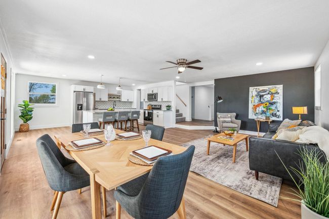 Dining room featuring light wood finished floors, recessed lighting, stairs, and a ceiling fan | Image 7