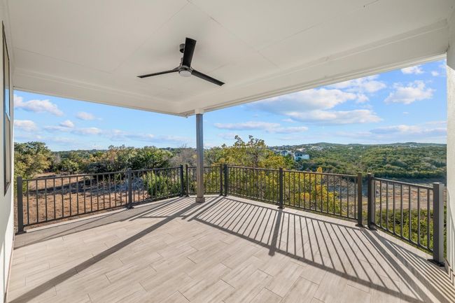 A captivating balcony offers a front-row seat to breathtaking panoramic views of the Hill Country, providing the perfect setting to relax, unwind, and take in the beauty of the surroundings. Thoughtfully designed for both elegance and comfort, this outdoor retreat enhances the home’s seamless connection to nature. | Image 34