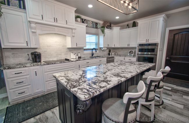 Granite center island with barstool seating | Image 13
