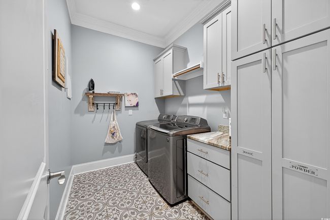Washroom featuring cabinet space, washing machine and dryer, crown molding, recessed lighting, and tile patterned floors | Image 29
