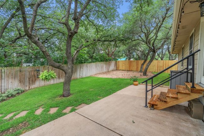 Fenced backyard with a patio area | Image 30