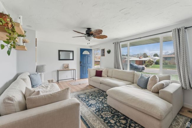Living room featuring ceiling fan, baseboards, and light wood-style floors | Image 5