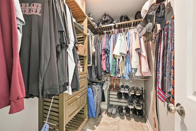 Find not just one, but TWO spacious walk-in closets with custom built-ins, multiple hanging areas, and open shelving—offering generous storage and organization for wardrobes of all sizes. | Image 13