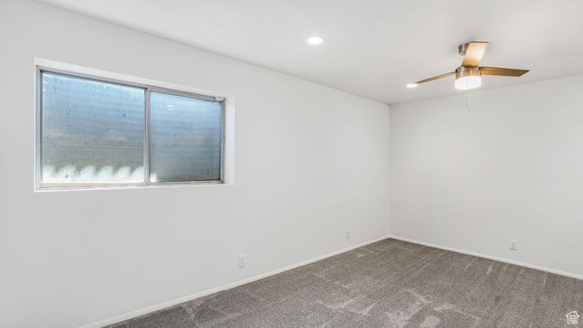 Unfurnished downstairs bedroom with recessed lighting, carpet flooring, baseboards, and a spacious closet | Image 15