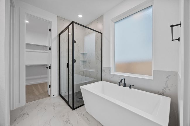 Full bath with a marble finish shower, a freestanding tub, a walk in closet, marble finish floors, and recessed lighting | Image 14